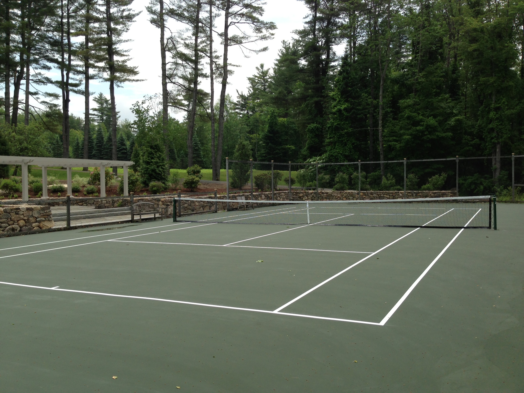 Professional tennis court installation in Dallas, Texas showing expert construction team at work